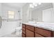 Bathroom features a granite countertop vanity, toilet, and tub with shower and white subway tile at 335 N 11Th Ave, Brighton, CO 80601