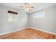 This bedroom features hardwood floors, neutral walls, and a ceiling fan with a light fixture at 335 N 11Th Ave, Brighton, CO 80601