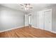 Bright bedroom featuring hardwood floors, ceiling fan, and a closet at 335 N 11Th Ave, Brighton, CO 80601