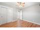 This bedroom features hardwood floors, neutral walls, and a closet with white sliding doors at 335 N 11Th Ave, Brighton, CO 80601