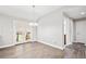Bright dining room featuring stylish light fixture, wood-look flooring, and french doors to back patio at 335 N 11Th Ave, Brighton, CO 80601