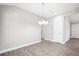 Bright dining room featuring wood-look floors and contemporary chandelier lighting at 335 N 11Th Ave, Brighton, CO 80601