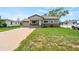 Charming home featuring stone accents, well-maintained lawn, and a driveway leading to a garage at 335 N 11Th Ave, Brighton, CO 80601