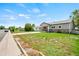 Charming home featuring stone accents, well-maintained lawn, and a driveway leading to a garage at 335 N 11Th Ave, Brighton, CO 80601