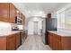 Modern kitchen with stainless steel appliances and abundant wood cabinetry at 335 N 11Th Ave, Brighton, CO 80601