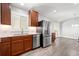 Bright and airy kitchen with stainless steel appliances and wood cabinets at 335 N 11Th Ave, Brighton, CO 80601