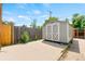 Wooden backyard shed with double doors and concrete pad at 335 N 11Th Ave, Brighton, CO 80601