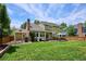 Expansive backyard with lush lawn, deck, grill, and mature landscaping at 16177 E Prentice Pl, Centennial, CO 80015