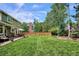Green backyard offering mature trees, manicured lawn, deck and fencing at 16177 E Prentice Pl, Centennial, CO 80015