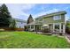 Large green backyard with wooden deck, patio seating, and well-maintained lawn at 16177 E Prentice Pl, Centennial, CO 80015
