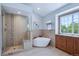 Bright bathroom featuring soaking tub, and glass-enclosed shower at 16177 E Prentice Pl, Centennial, CO 80015