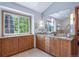 Bathroom featuring wood cabinets, granite countertop and a window at 16177 E Prentice Pl, Centennial, CO 80015