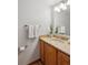 Well-maintained bathroom with a granite countertop vanity, a decorative mirror, and essential fixtures at 16177 E Prentice Pl, Centennial, CO 80015