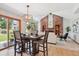 Open concept dining area featuring hardwood floors, stylish lighting, and a sliding glass door for natural light at 16177 E Prentice Pl, Centennial, CO 80015