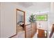 Open hallway leading to a bedroom, featuring hardwood floors, natural light, and a view of the staircase at 16177 E Prentice Pl, Centennial, CO 80015