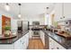 Spacious kitchen features granite countertops, stainless steel appliances, and white cabinets at 16177 E Prentice Pl, Centennial, CO 80015