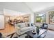 Bright living room with hardwood floors and large windows, offering an inviting space and backyard views at 16177 E Prentice Pl, Centennial, CO 80015