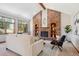 Cozy living room showcasing a brick fireplace, built-in shelving, and a comfortable seating arrangement at 16177 E Prentice Pl, Centennial, CO 80015