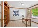 Home office featuring built-in bookshelves, a wooden desk, and a window providing ample natural light at 16177 E Prentice Pl, Centennial, CO 80015