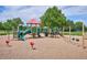 Colorful playground with slides, swings, and climbing structures set on a soft, sandy surface at 16177 E Prentice Pl, Centennial, CO 80015