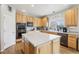 Beautiful kitchen featuring hardwood floors, light wood cabinetry, an island and stainless-steel appliances at 6373 E 130Th Ave, Thornton, CO 80602