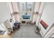 Top-down view of a living room with high ceilings, fireplace, office space, and floor-to-ceiling curtains at 6373 E 130Th Ave, Thornton, CO 80602