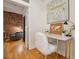 Charming home office with exposed brick wall and a marble desk at 800 E 18Th Ave # 105, Denver, CO 80218