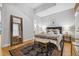 Main bedroom with exposed brick wall and large mirror at 800 E 18Th Ave # 105, Denver, CO 80218