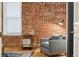 Cozy sitting area with exposed brick wall and comfortable armchair at 800 E 18Th Ave # 105, Denver, CO 80218