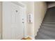 Interior hallway with white door and carpeted staircase at 800 E 18Th Ave # 105, Denver, CO 80218