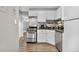 Bright kitchen with white cabinetry, gray countertops, and stainless steel appliances at 63 S Sable Blvd # 16, Aurora, CO 80012