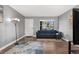 Bright living room with modern lighting, a large window, and a comfortable blue sofa at 63 S Sable Blvd # 16, Aurora, CO 80012