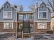 Two-story duplex with gray siding and brick at 63 S Sable Blvd # 16, Aurora, CO 80012
