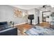 Living room includes a comfy couch, large TV, and wood-look floors at 63 S Sable Blvd # 16, Aurora, CO 80012