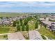 Expansive community aerial shot with walking paths and a pond, nestled among cozy homes at 14258 Greenfield Loop, Parker, CO 80134
