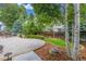 Features lush lawn and stone patio surrounded by landscaping and mature trees at 14258 Greenfield Loop, Parker, CO 80134