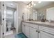 Bright bathroom with dual sinks, ample counter space, and adjacent toilet area at 14258 Greenfield Loop, Parker, CO 80134