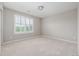 Sunny bedroom with plush neutral carpet, large window with blinds, and ample natural light at 14258 Greenfield Loop, Parker, CO 80134