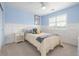 Cozy bedroom with decorative wainscoting, bright window, and modern ceiling fan at 14258 Greenfield Loop, Parker, CO 80134