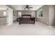 Spacious carpeted bedroom with a large bed, and two bright windows with a view at 14258 Greenfield Loop, Parker, CO 80134