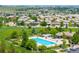 Enjoy this community pool with lounge seating, a covered patio, and lush landscaping at 14258 Greenfield Loop, Parker, CO 80134