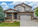 Charming two-story home featuring a covered porch and a well-maintained lawn, perfect for suburban living at 14258 Greenfield Loop, Parker, CO 80134