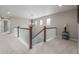 Upstairs hallway with natural light, decorative light fixture, and wood and white railing at 14258 Greenfield Loop, Parker, CO 80134