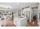 Open-concept kitchen with a center island that seamlessly transitions into a dining and living area at 14258 Greenfield Loop, Parker, CO 80134