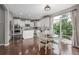 Open concept kitchen with white cabinetry, stainless steel appliances, and a view to the backyard patio at 14258 Greenfield Loop, Parker, CO 80134