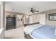 Spacious main bedroom with a ceiling fan, large dresser, and adjacent bathroom and walk in closet at 14258 Greenfield Loop, Parker, CO 80134