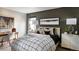 Bedroom with a bed, desk, and dark green accent wall at 4237 Ridgewalk Pt, Castle Rock, CO 80108