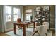 Bright home office with built-in shelving, large windows, and comfortable seating at 4237 Ridgewalk Pt, Castle Rock, CO 80108