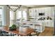 Open concept kitchen with white cabinets, quartz countertops, and an island at 4237 Ridgewalk Pt, Castle Rock, CO 80108