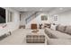 Finished basement with stairs and a cozy seating area with a large sectional and entertainment area at 4590 Wolff St, Denver, CO 80212